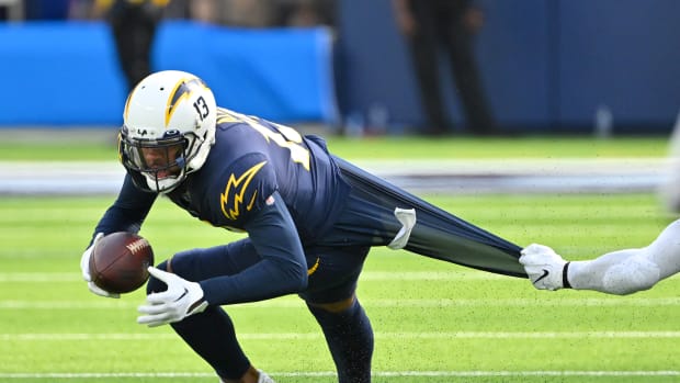 Oct 23, 2022; Inglewood, California, USA; Los Angeles Chargers wide receiver Keenan Allen (13) runs for a first down before he is stopped by Seattle Seahawks linebacker Jordyn Brooks (56) in the first half at SoFi Stadium. Mandatory Credit: Jayne Kamin-Oncea-USA TODAY Sports